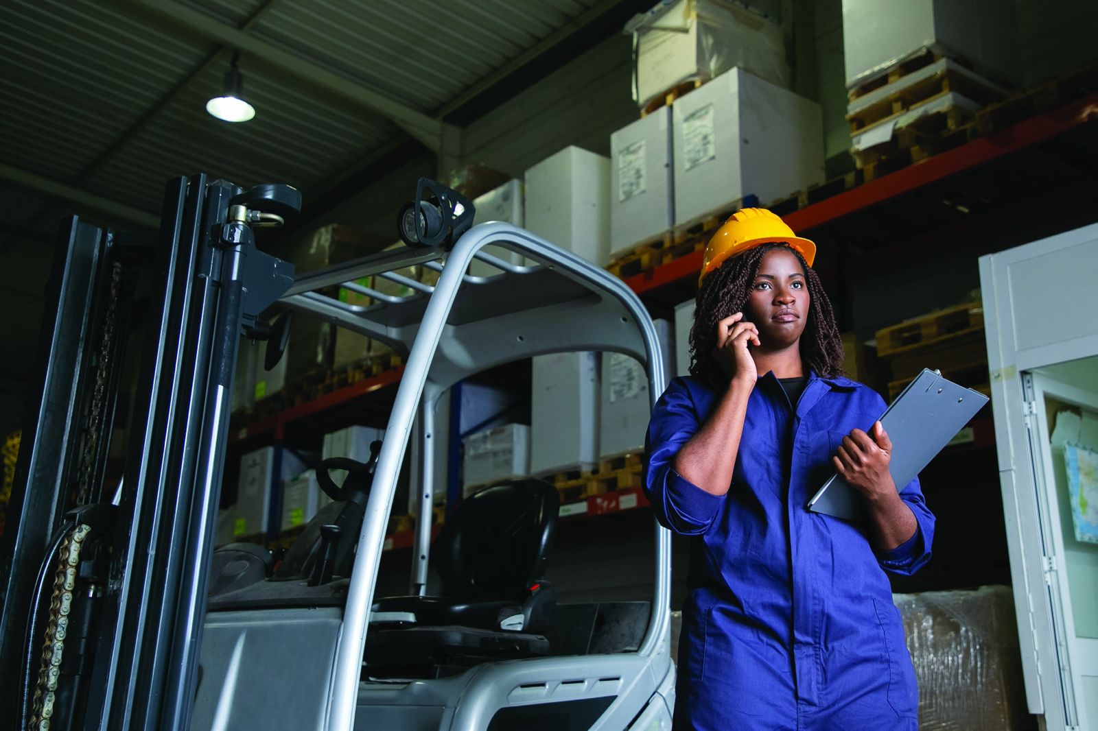 Industrial warehouse with equipment and a professional in protective clothing